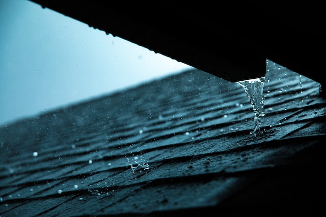 Rain water on a roof on a dark cloudy day