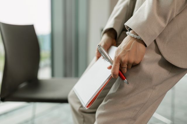 a person holding a notebook