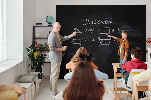 a teacher in front of his class teaching a math lesson