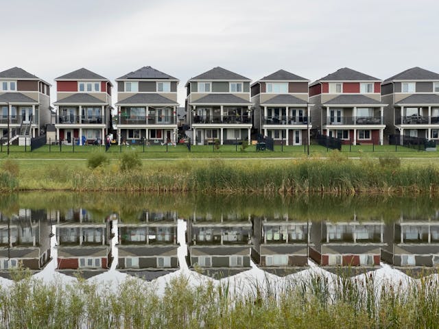 houses lined up in front of a pond