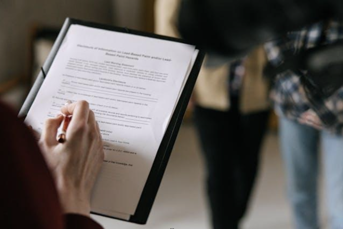 a person signing a leasing agreement