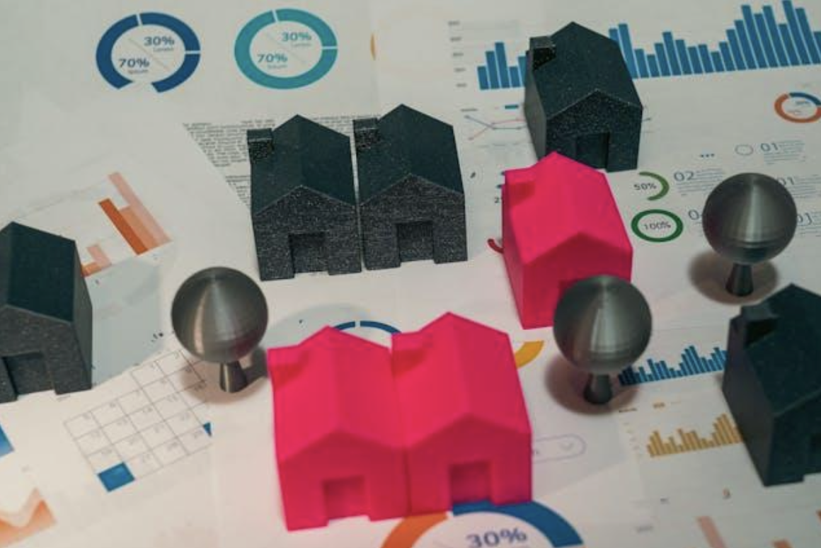 small house figurines on charts